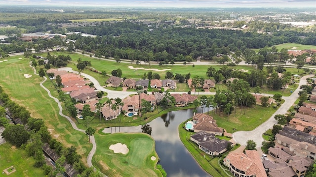 aerial view with golf course view, a water view, and a residential view