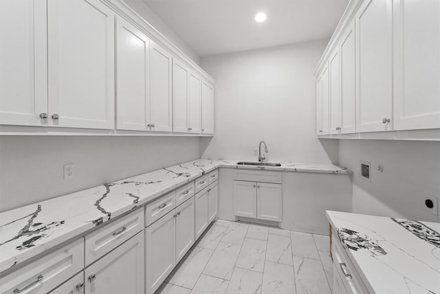 laundry room featuring hookup for a washing machine, recessed lighting, a sink, marble finish floor, and cabinet space