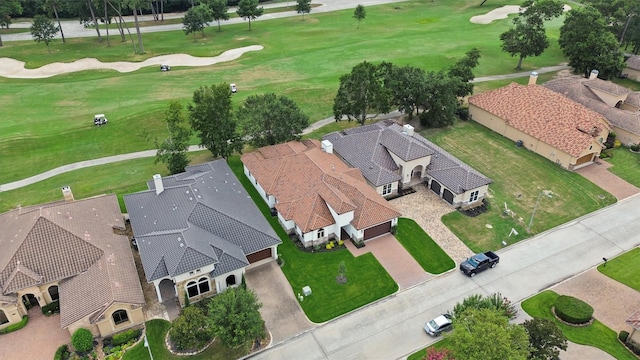 drone / aerial view featuring golf course view and a residential view