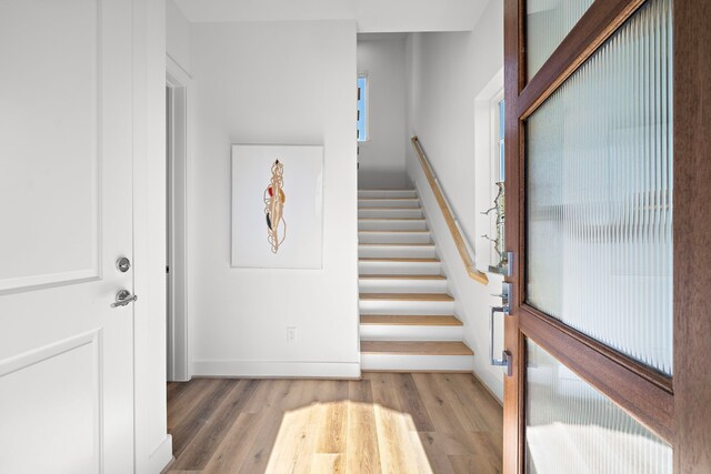 staircase with hardwood / wood-style flooring