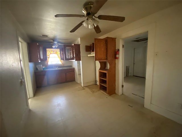 kitchen with ceiling fan, light tile patterned floors, and sink