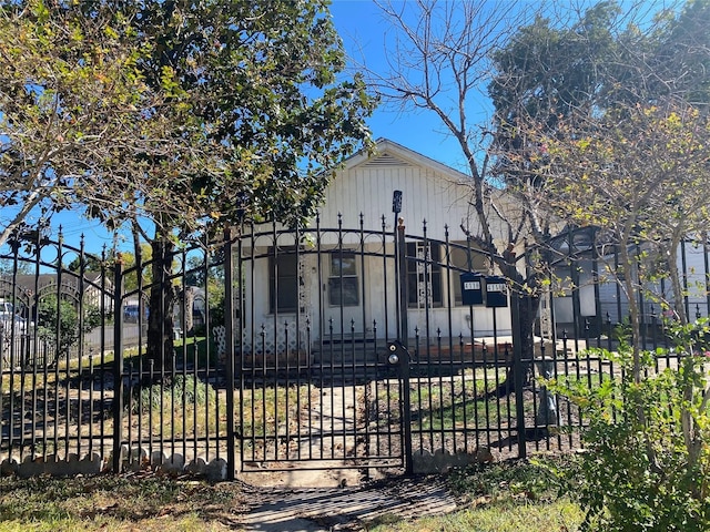 view of gate with a fenced front yard