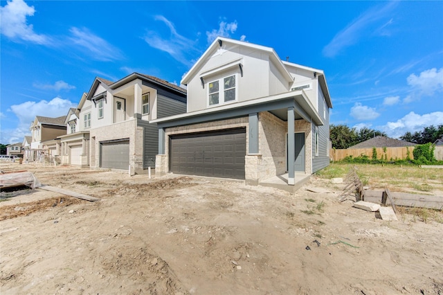 view of front of property with a garage and fence