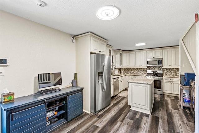 kitchen featuring light stone counters, sink, decorative backsplash, dark hardwood / wood-style floors, and appliances with stainless steel finishes