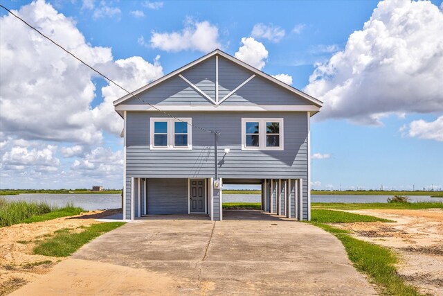 view of front of house featuring a garage and a water view