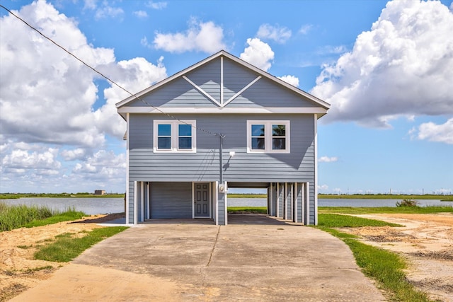 exterior space with a garage, a carport, and a water view