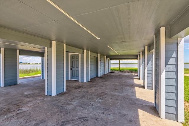 view of patio featuring a carport and a water view