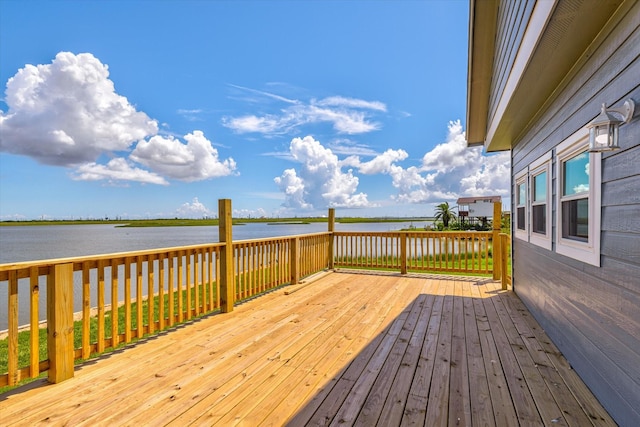 wooden terrace featuring a water view