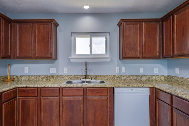 kitchen with light stone counters, recessed lighting, dishwasher, and a sink