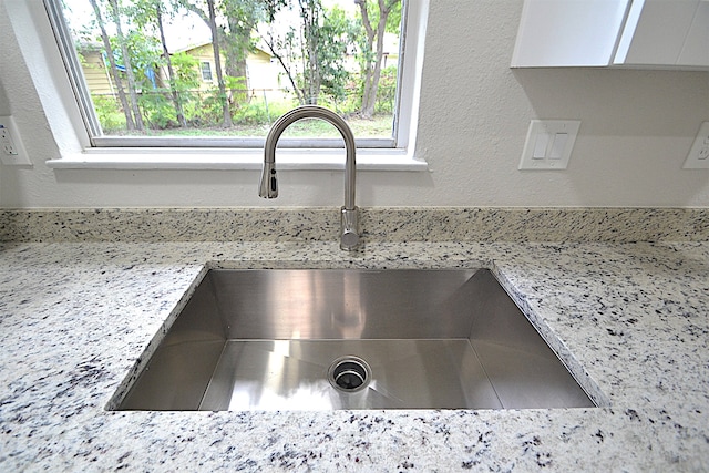 details featuring sink and light stone counters