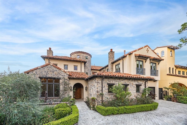 mediterranean / spanish-style home featuring a garage