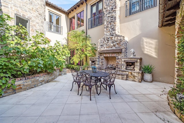 view of patio / terrace with an outdoor stone fireplace