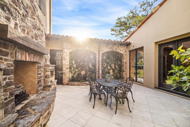 view of patio / terrace with an outdoor stone fireplace