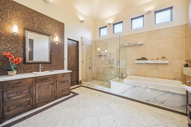 bathroom featuring independent shower and bath, vanity, and tile walls