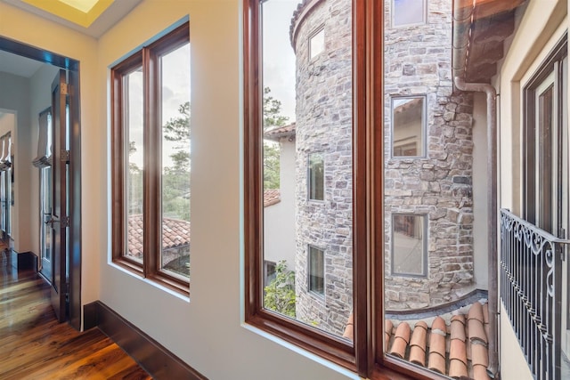 corridor featuring dark hardwood / wood-style floors and a healthy amount of sunlight