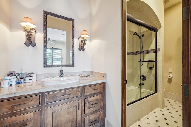 bathroom with vanity and combined bath / shower with glass door