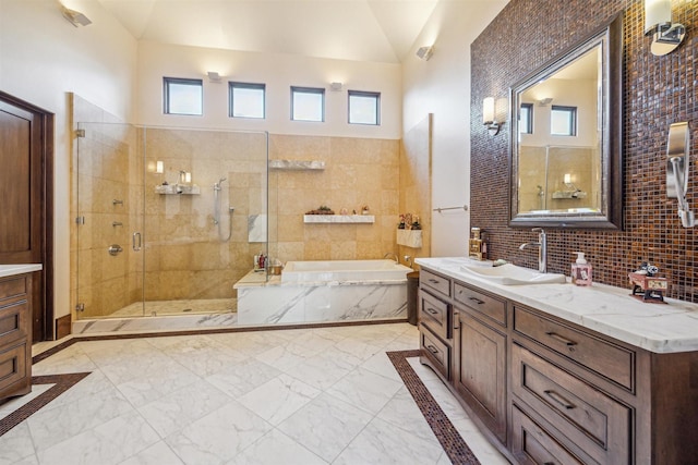 bathroom with lofted ceiling, vanity, plenty of natural light, and shower with separate bathtub