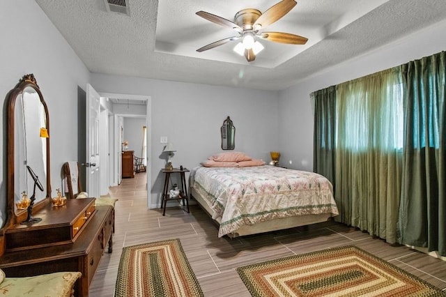 bedroom with a textured ceiling and ceiling fan