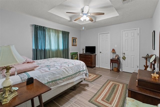 bedroom with a textured ceiling and ceiling fan