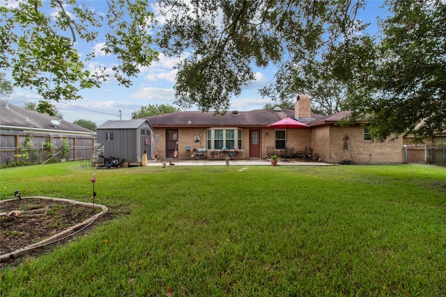 back of property with a patio, a storage unit, and a lawn