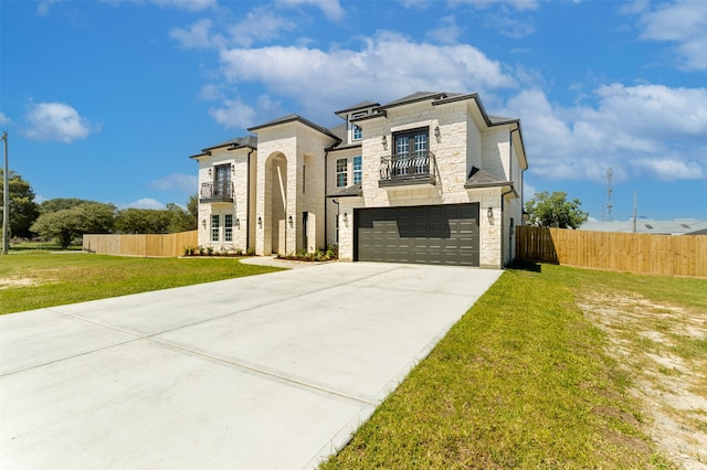 view of front of property featuring a balcony, a garage, and a front lawn