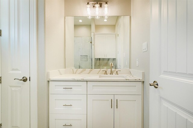 bathroom featuring vanity and an enclosed shower