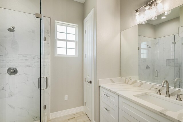 bathroom featuring vanity, hardwood / wood-style flooring, and walk in shower