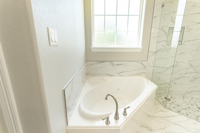 1714 Mackey Dr, Dickinson, TX 77539 - bathroom featuring a tub with jets, a marble finish shower, marble finish floors, and a textured wall