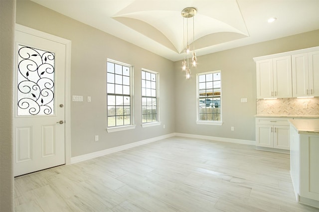 1714 Mackey Dr, Dickinson, TX 77539 - unfurnished dining area featuring baseboards, a chandelier, and light wood-type flooring