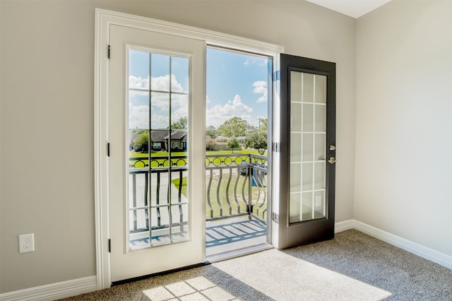 entryway featuring french doors and light colored carpet