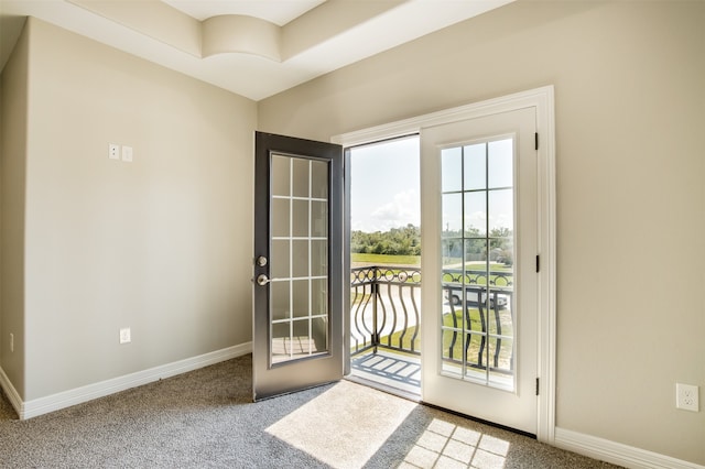 doorway to outside featuring carpet flooring