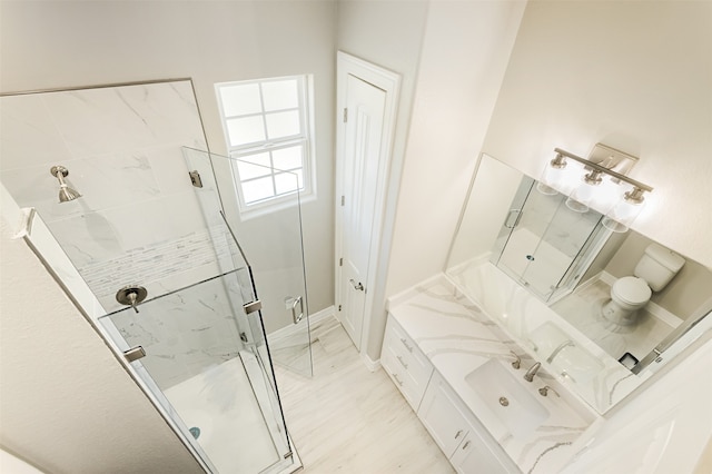 bathroom featuring vanity and a shower with door