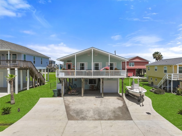 coastal inspired home featuring a garage and a front yard