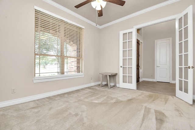 empty room with carpet flooring, ceiling fan, french doors, and ornamental molding