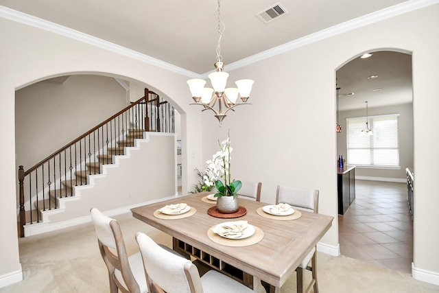 dining space featuring a notable chandelier, light tile patterned floors, and ornamental molding