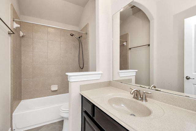 full bathroom featuring vanity, tiled shower / bath combo, tile patterned floors, and toilet