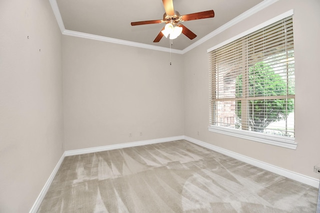 spare room featuring light carpet, ceiling fan, and ornamental molding