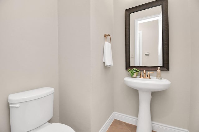 bathroom with tile patterned flooring and toilet