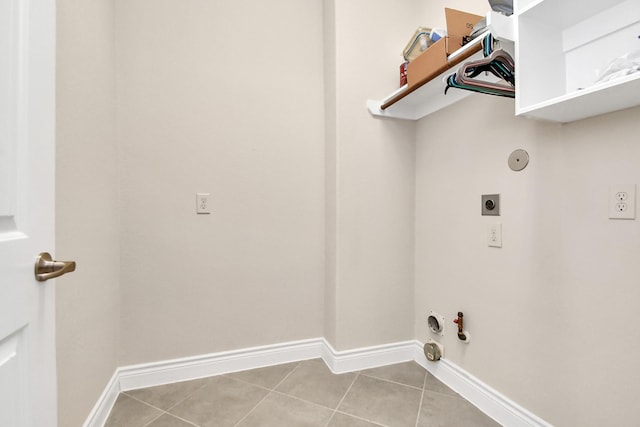 washroom featuring hookup for an electric dryer, hookup for a gas dryer, and light tile patterned flooring