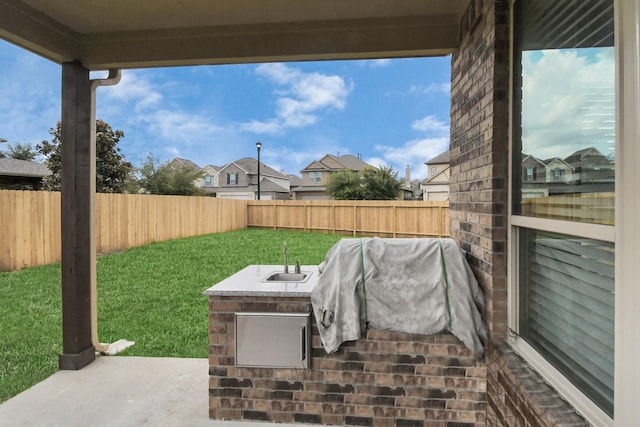 view of patio / terrace featuring exterior kitchen and sink