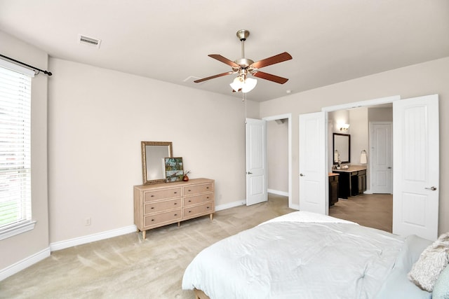 bedroom with carpet flooring, ceiling fan, and ensuite bathroom