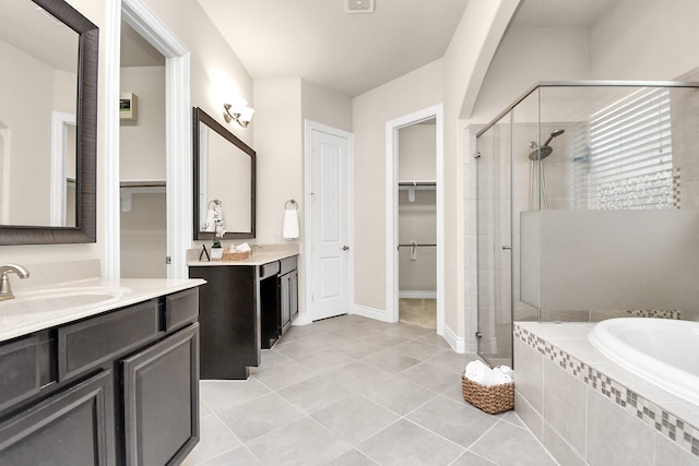 bathroom featuring tile patterned floors, vanity, and plus walk in shower