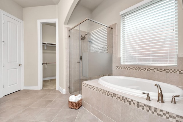 bathroom featuring tile patterned floors and independent shower and bath