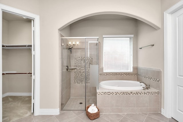 bathroom featuring tile patterned flooring and plus walk in shower