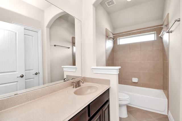 full bathroom with vanity, tile patterned flooring, tiled shower / bath, and toilet