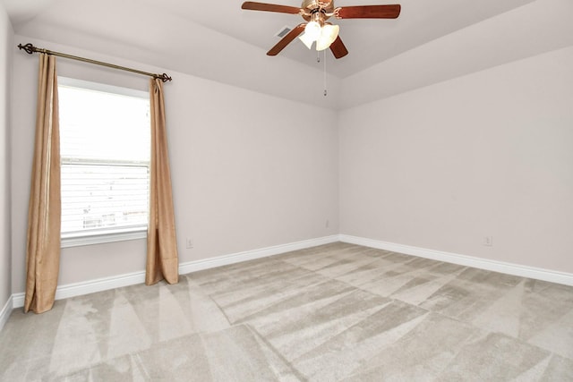 carpeted spare room with ceiling fan and lofted ceiling