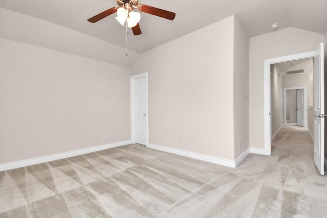 carpeted spare room with ceiling fan and lofted ceiling