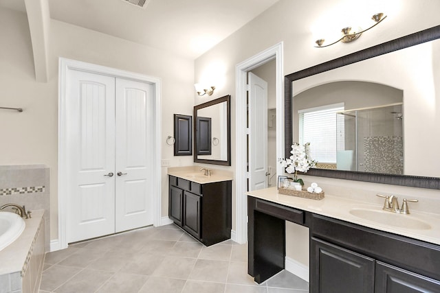 bathroom featuring tile patterned flooring, shower with separate bathtub, and vanity