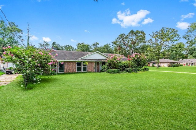 ranch-style home with a front lawn