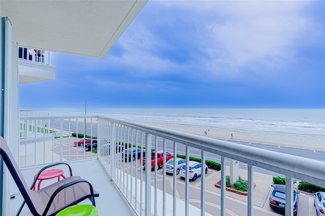 balcony with a beach view and a water view